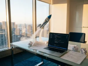 Rocket ship model launching from glass desk surrounded by code printouts and laptop showing development frameworks