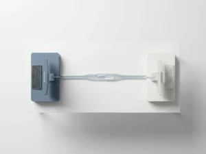 Fiber-optic cable bundle linking two minimalist workstations on a white desk, shot from above with soft studio lighting and cool slate blue accents.